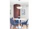 Bright dining area features a round table with blue chairs and modern lighting fixture at 460 S Marion Pkwy # 1701, Denver, CO 80209