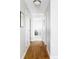 Bright hallway with hardwood floors leading to a bedroom with neutral decor at 460 S Marion Pkwy # 1701, Denver, CO 80209