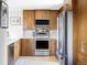 Modern kitchen features stainless appliances, light countertops, and wood cabinets, for a stylish space at 460 S Marion Pkwy # 1701, Denver, CO 80209