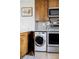 Efficient kitchen with stainless steel appliances, modern cabinetry, and integrated laundry appliances at 460 S Marion Pkwy # 1701, Denver, CO 80209