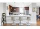 Kitchen with bar seating, wood cabinets, granite countertops, and stainless steel appliances at 460 S Marion Pkwy # 1701, Denver, CO 80209