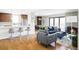 Bright living room showcasing a modern fireplace, hardwood floors, and seamless open-concept design at 460 S Marion Pkwy # 1701, Denver, CO 80209