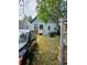 An outdoor space with mixed grass, paved walkway, storage shed, and parking at 4316 Josephine St, Denver, CO 80216