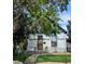 Charming home featuring unique architectural details, light grey brick, and a well-maintained front yard at 4316 Josephine St, Denver, CO 80216
