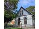 Charming home featuring unique architectural details, light grey brick, and a well-maintained front yard with trees at 4316 Josephine St, Denver, CO 80216