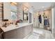 Elegant bathroom with double sinks, stone feature wall and large shower at 3915 W Byron Pl, Denver, CO 80212