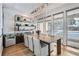 Elegant dining room with a large wooden table and statement chandelier at 3915 W Byron Pl, Denver, CO 80212