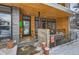 Modern home entry with wood and stone details, snowy porch at 3915 W Byron Pl, Denver, CO 80212