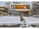 Modern two-story home with wood and gray siding, snowy front yard at 3915 W Byron Pl, Denver, CO 80212