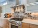 Modern kitchen with stainless steel appliances and wood cabinets at 3915 W Byron Pl, Denver, CO 80212