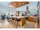 Modern kitchen with wood cabinets, large island, and stainless steel appliances at 3915 W Byron Pl, Denver, CO 80212