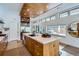 Modern kitchen with a large island, stainless steel appliances, and wood cabinets at 3915 W Byron Pl, Denver, CO 80212