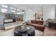 Spacious living room with a modern fireplace and leather couch at 3915 W Byron Pl, Denver, CO 80212