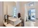 Modern powder room features a sleek sink and access to a private backyard at 3915 W Byron Pl, Denver, CO 80212