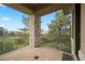 Balcony with stone pillars and a glass railing overlooking scenic landscape views at 606 Cliffgate Ln, Castle Rock, CO 80108