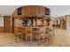 Entertainment room with a large curved bar, multiple TVs, barstools, and wood accents at 606 Cliffgate Ln, Castle Rock, CO 80108