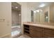 Bathroom with a stone countertop vanity and glass enclosed shower with a built-in bench at 606 Cliffgate Ln, Castle Rock, CO 80108