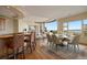 Open dining area with bar, fireplace, hardwood floors, and floor-to-ceiling windows with stunning mountain views at 606 Cliffgate Ln, Castle Rock, CO 80108