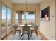 Bright dining area with modern decor, mountain views, and access to outdoor patio at 606 Cliffgate Ln, Castle Rock, CO 80108