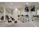 Well-lit exercise room featuring mirrors, workout equipment, and a mounted television at 606 Cliffgate Ln, Castle Rock, CO 80108