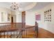 Grand foyer with hardwood floors, curved staircase, chandelier and elegant decor at 606 Cliffgate Ln, Castle Rock, CO 80108