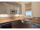 Modern kitchen with stainless steel appliances, countertop and under cabinet lighting at 606 Cliffgate Ln, Castle Rock, CO 80108