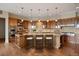 Well-appointed kitchen features a large island with seating, stainless steel appliances, and stylish pendant lighting at 606 Cliffgate Ln, Castle Rock, CO 80108
