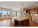 Open kitchen featuring a large island, granite countertops, custom cabinetry, and views at 606 Cliffgate Ln, Castle Rock, CO 80108