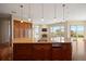 Kitchen boasts island with sink, custom wood cabinets and stainless steel appliances at 606 Cliffgate Ln, Castle Rock, CO 80108