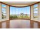 Spacious living area featuring dark-stained floors and a large view window to bring the outdoors in at 606 Cliffgate Ln, Castle Rock, CO 80108