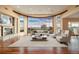 Spacious living area featuring a stone fireplace, sleek furniture, hardwood floors, and mountain views at 606 Cliffgate Ln, Castle Rock, CO 80108