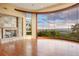 This living area has dark-stained floors, stone fireplace, and a large view window to bring the outdoors in at 606 Cliffgate Ln, Castle Rock, CO 80108