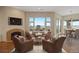 Cozy living room with a fireplace, comfortable seating, and a large window with scenic views at 606 Cliffgate Ln, Castle Rock, CO 80108