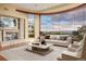 Bright living room boasts a stone fireplace, hardwood floors, and stunning views of the surrounding landscape at 606 Cliffgate Ln, Castle Rock, CO 80108