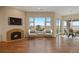 Comfortable living room with large windows, fireplace, and access to the outdoors at 606 Cliffgate Ln, Castle Rock, CO 80108