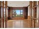 Spacious living room boasts hardwood floors, custom built-ins and gorgeous mountain views at 606 Cliffgate Ln, Castle Rock, CO 80108