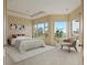 Staged bedroom with neutral tones, large windows with scenic views, and a comfortable seating area at 606 Cliffgate Ln, Castle Rock, CO 80108