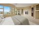 Spacious bedroom featuring a fireplace, seating area, and large windows with scenic mountain views at 606 Cliffgate Ln, Castle Rock, CO 80108