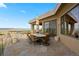 Outdoor patio with stone floors, umbrella-covered table, glass railings and scenic views at 606 Cliffgate Ln, Castle Rock, CO 80108