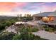 Estate home with luxury pool, patio, and manicured landscaping, ideal for outdoor entertaining, with sunset views at 606 Cliffgate Ln, Castle Rock, CO 80108