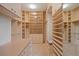 Spacious walk-in closet with custom shelving, drawers, and ample storage space at 606 Cliffgate Ln, Castle Rock, CO 80108
