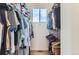 Walk-in closet with ample storage space and natural light from the window at 85 Uinta Way # 702, Denver, CO 80230