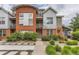 Contemporary townhome featuring a brick and metal facade and a welcoming landscaped entrance at 85 Uinta Way # 702, Denver, CO 80230