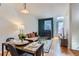 Cozy living room featuring a fireplace and an open dining area with modern decor and hardwood floors at 85 Uinta Way # 702, Denver, CO 80230