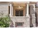 Charming balcony with seating, framed by elegant columns and lush greenery, enhancing curb appeal at 1301 N Ogden St # 1A, Denver, CO 80218