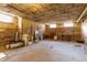Unfinished basement with exposed brick walls and original wood floors, offering renovation potential at 1301 N Ogden St # 1A, Denver, CO 80218