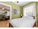 Bright bedroom showcasing large window and view into the living room at 1301 N Ogden St # 1A, Denver, CO 80218