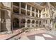 Exterior view of apartment building with arched entrance and courtyard at 1301 N Ogden St # 1A, Denver, CO 80218