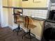 Bright dining area featuring a coffee bar and stylish chairs, adjacent to laundry at 1301 N Ogden St # 1A, Denver, CO 80218