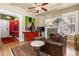 Inviting living room featuring hardwood floors, a fireplace, and a ceiling fan, complemented by colorful artwork at 1301 N Ogden St # 1A, Denver, CO 80218